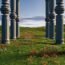 A Bunch of Pillars that are in the grass